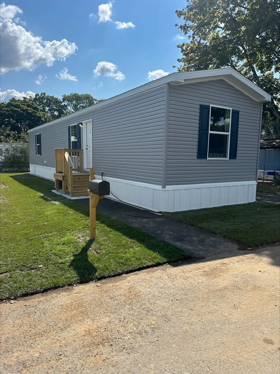 a front view of house with yard and outdoor seating