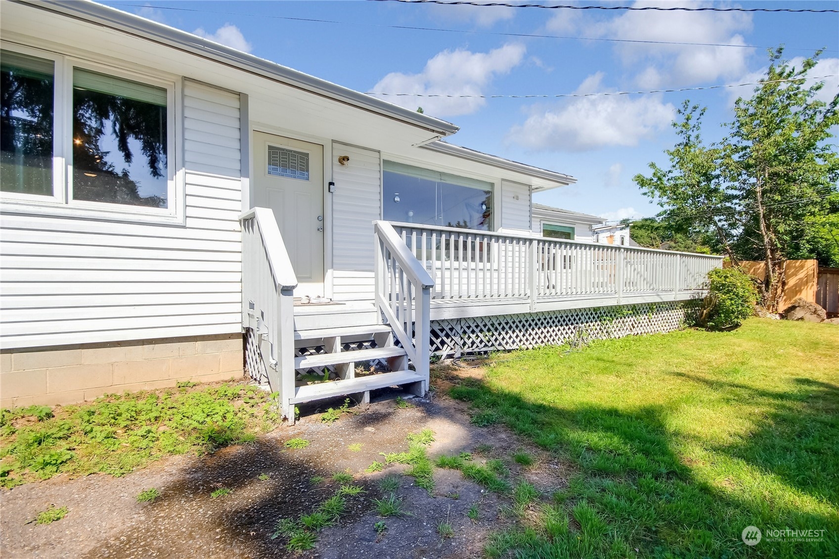 a view of a house with a yard and sitting area