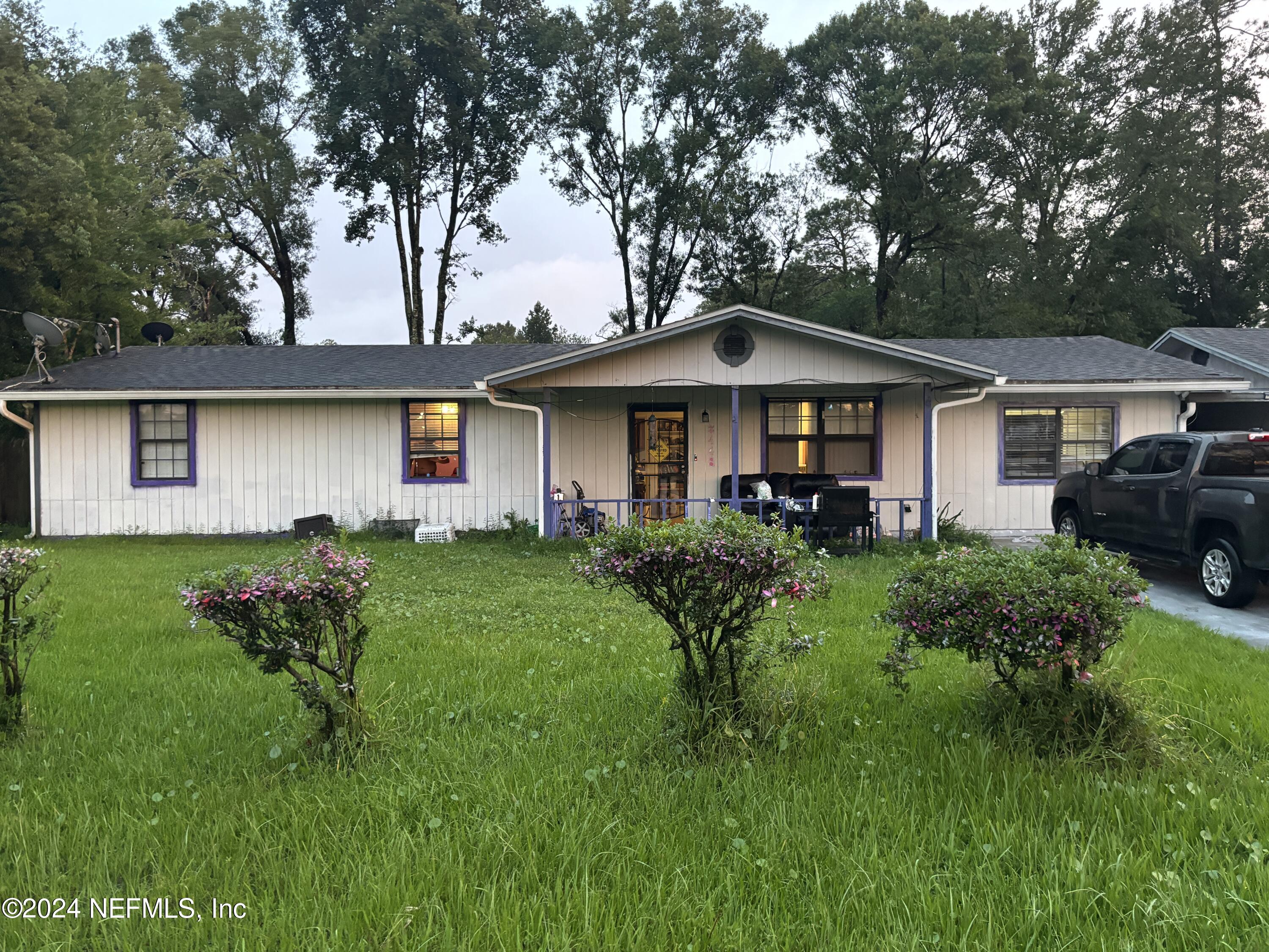 a front view of a house with garden