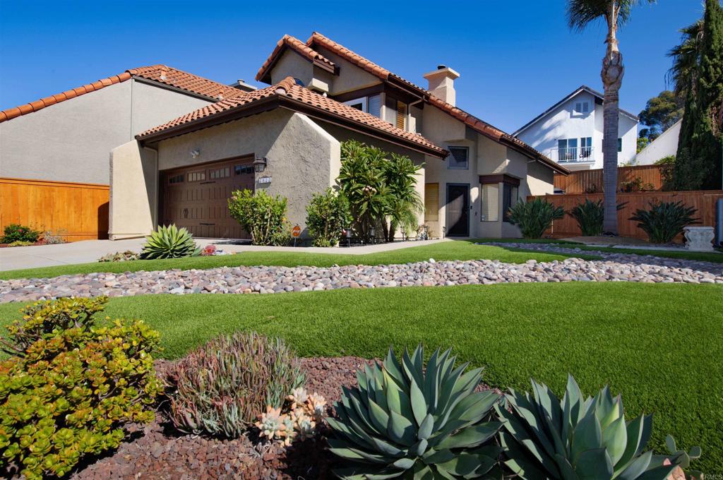 a view of a house with a small yard and plants