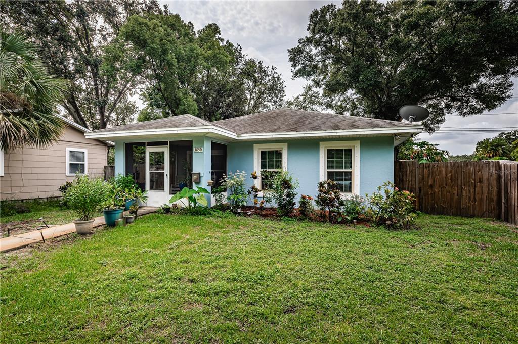 a front view of house with yard and green space