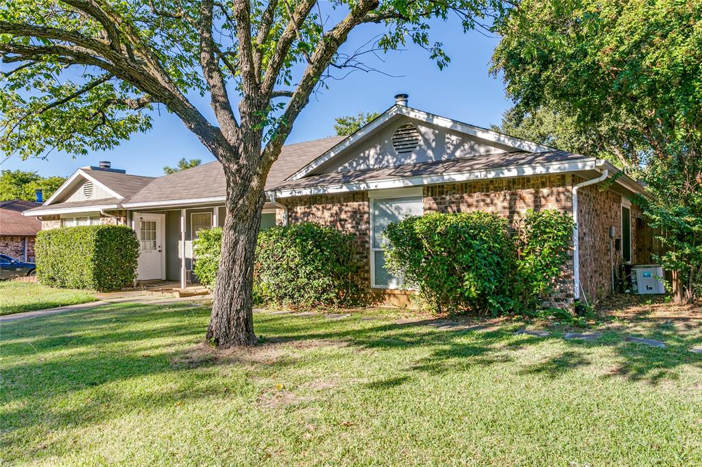 a view of a house with a tree in a yard