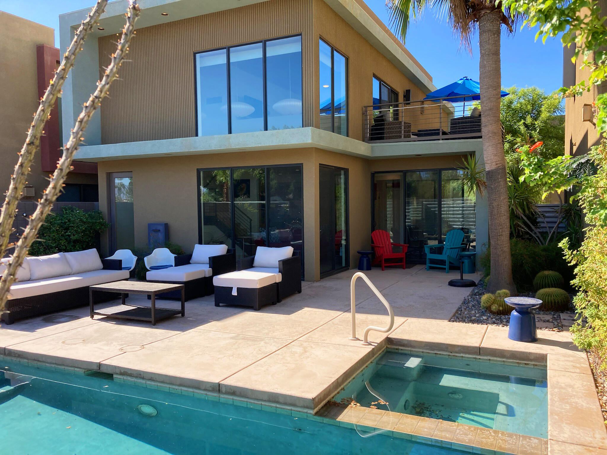 a view of a house with swimming pool and sitting area