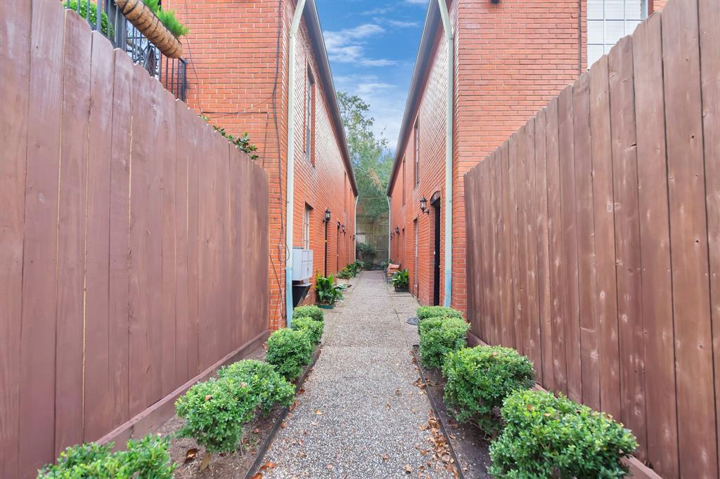 a view of a pathway with a wooden fence