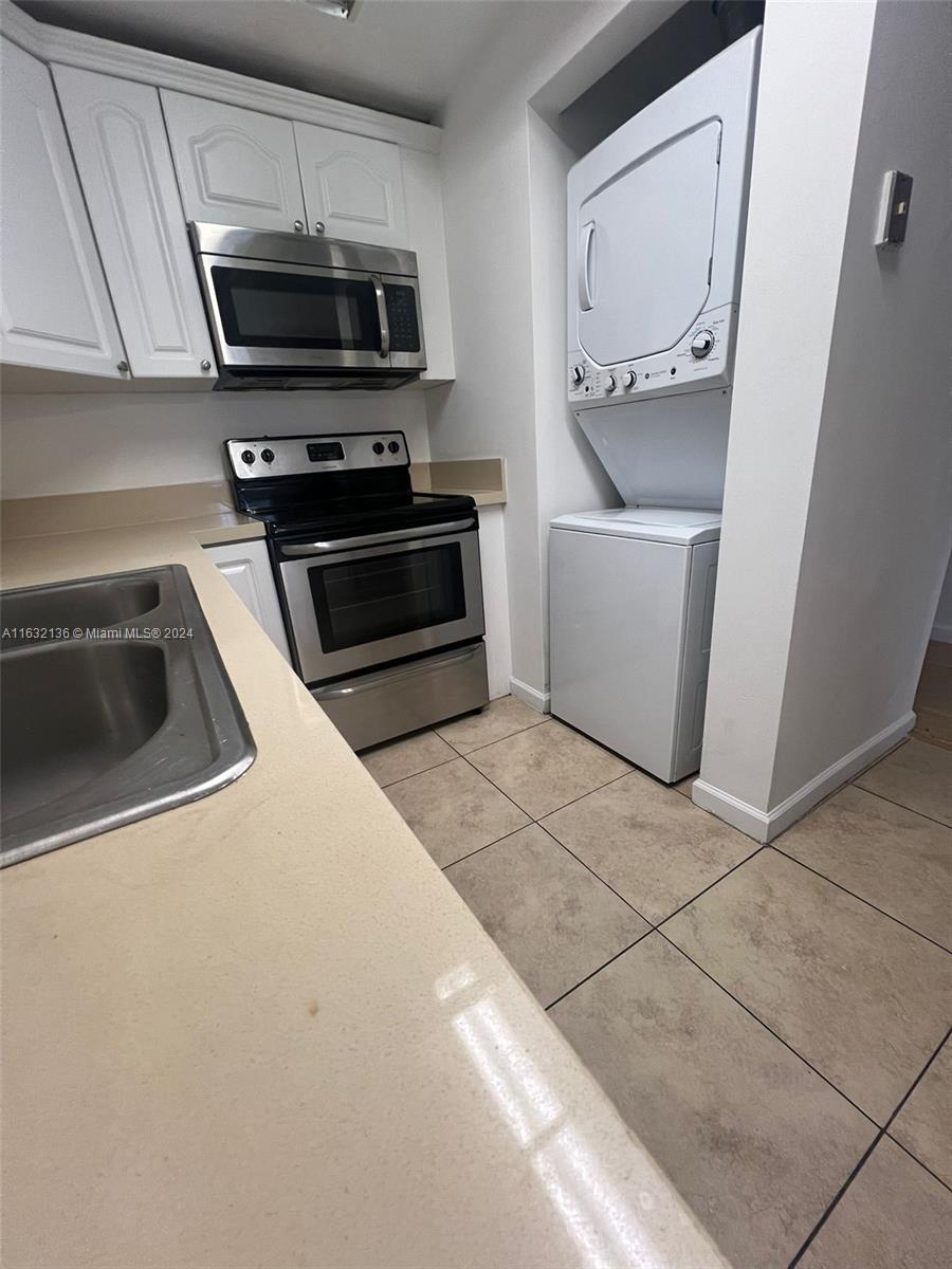 a kitchen with a sink and steel appliances