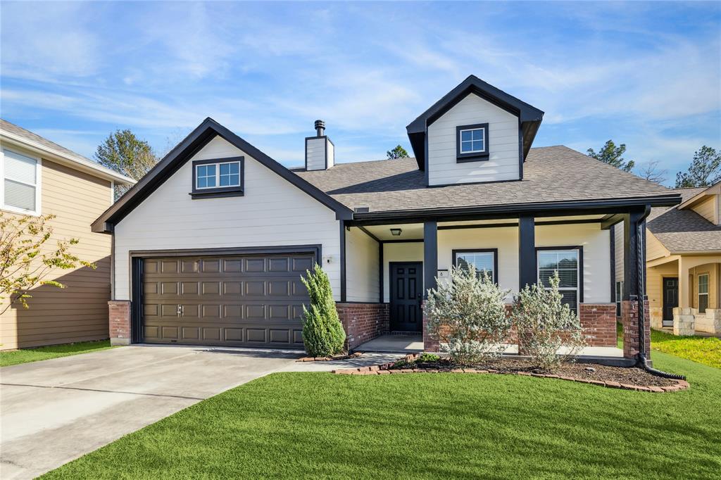 Charming one-story home with a covered porch and attached garage. Features a well-maintained lawn and modern design elements. Ideal for families looking for a cozy and inviting neighborhood.