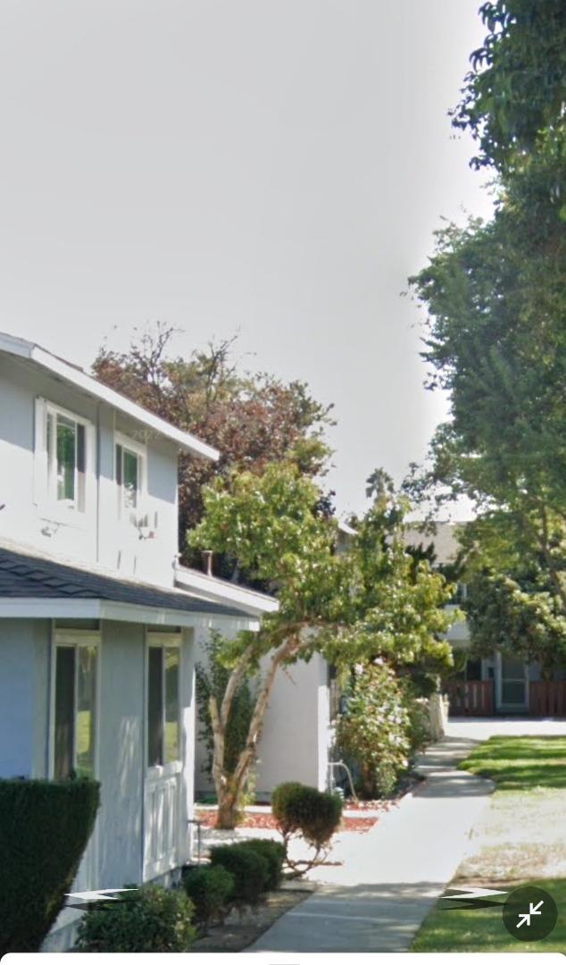 a front view of a house with a yard garage and outdoor seating