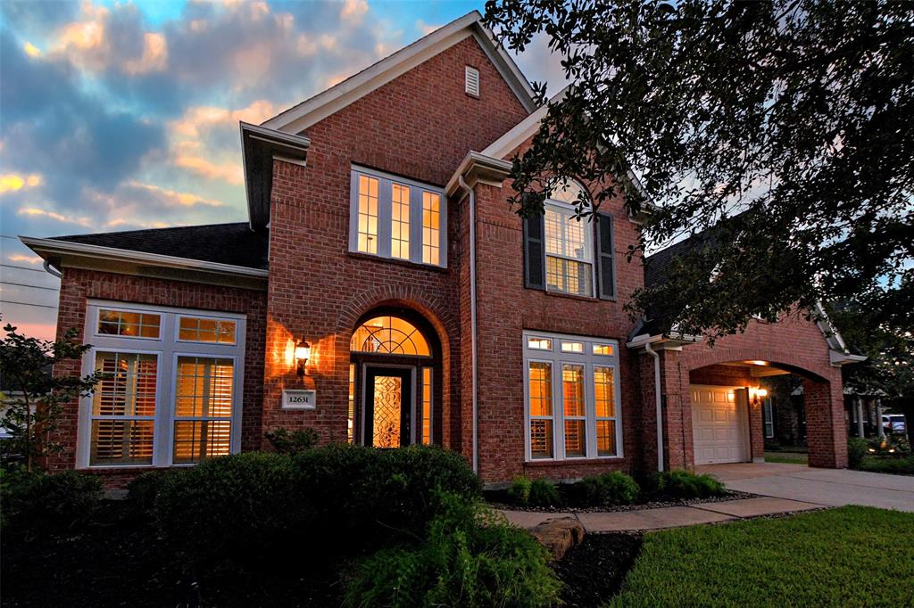 a front view of a house with lots of garden