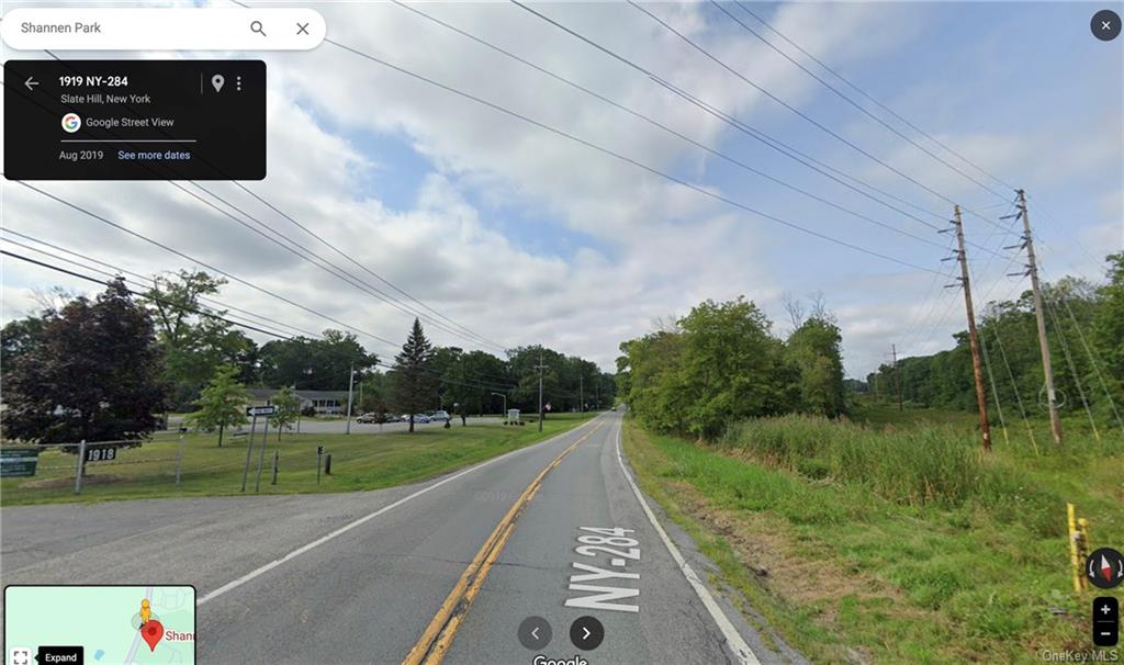 a view of a street with a yard