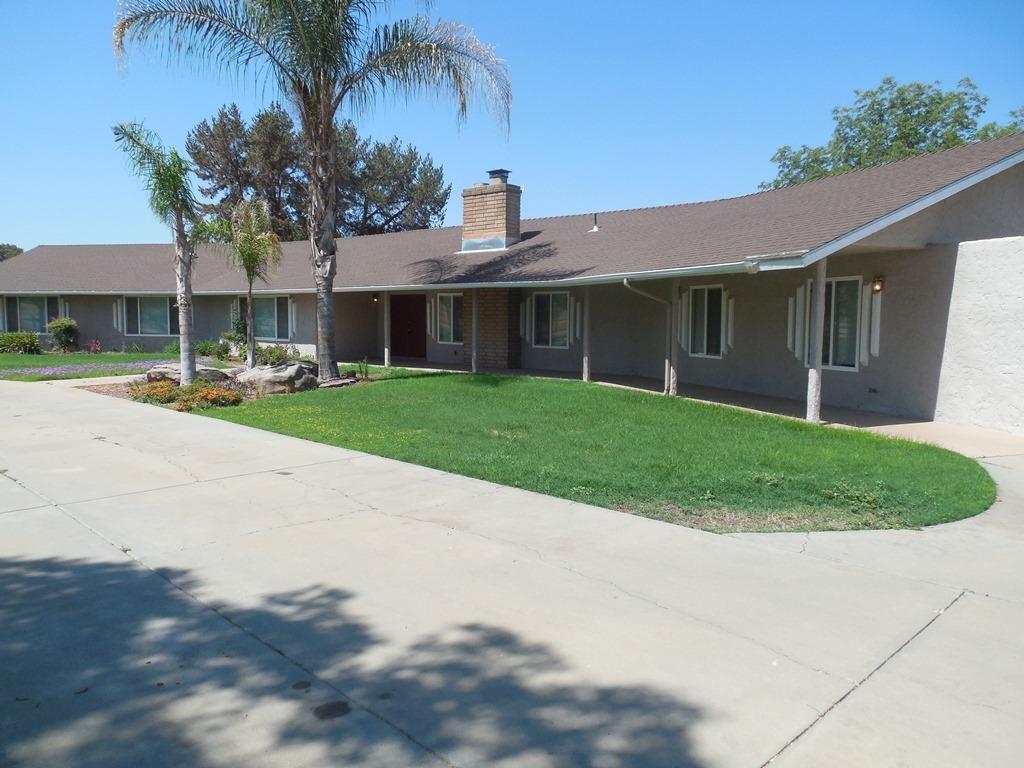 a front view of a house with a garden and plants