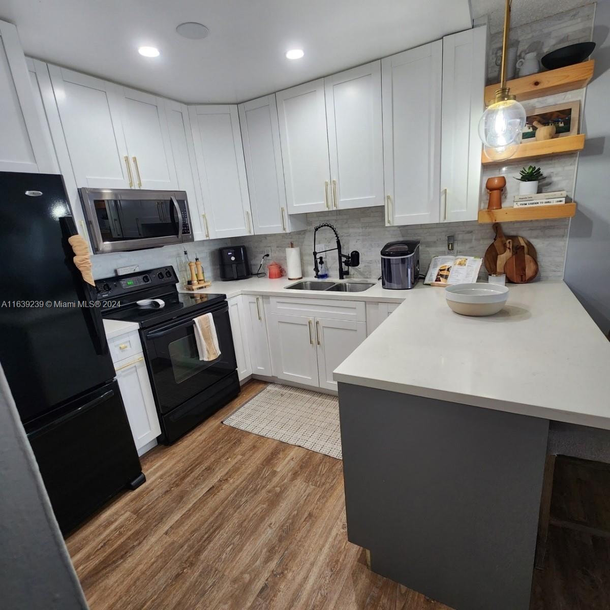 a kitchen with a sink a stove and cabinets