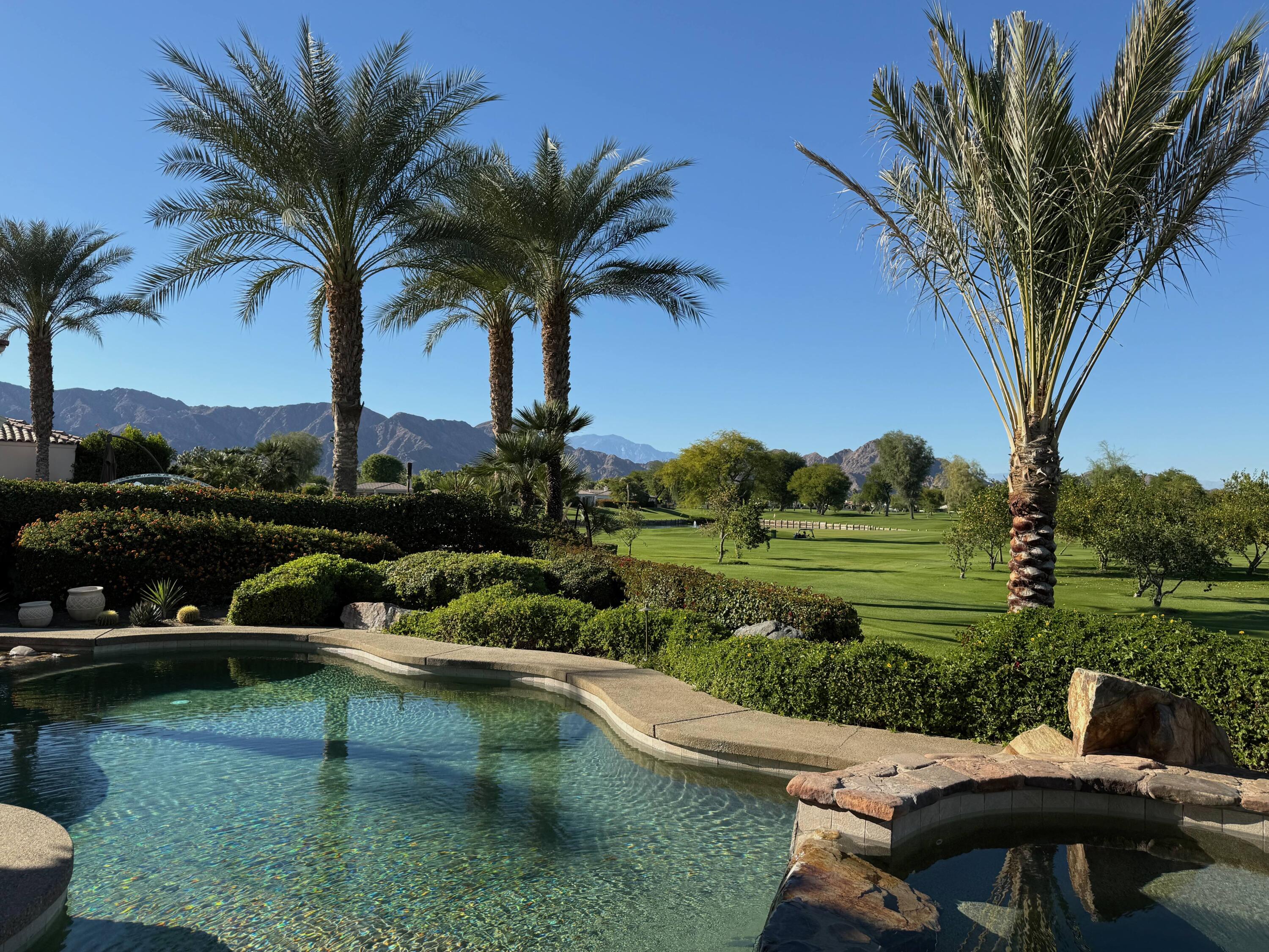 a view of a swimming pool and lounge chairs