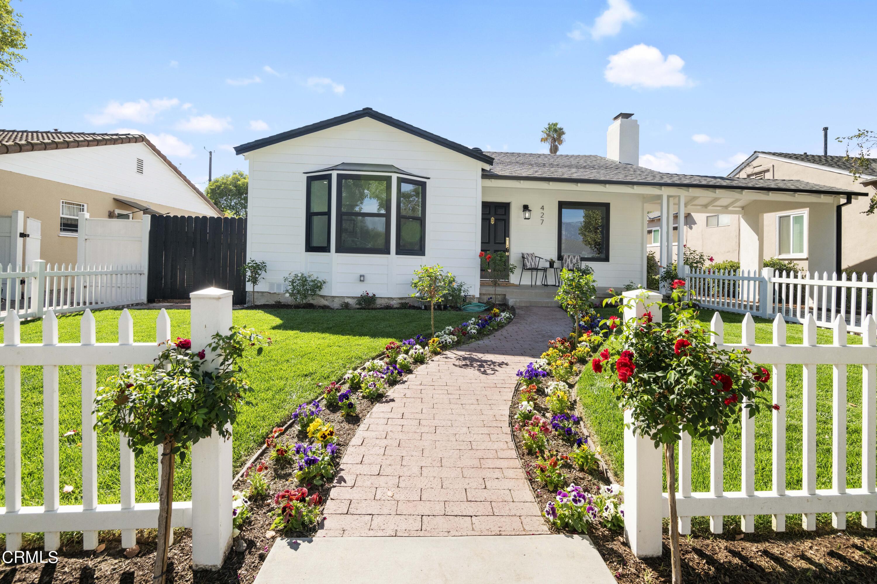 a front view of a house with a porch and a yard