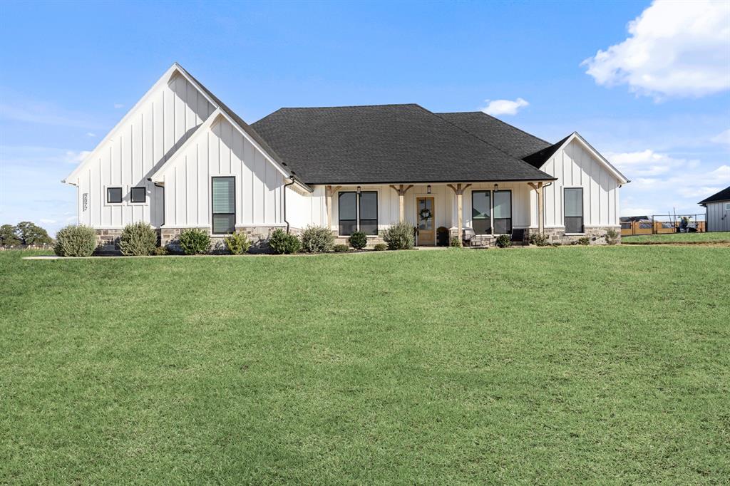 a front view of a house with a yard