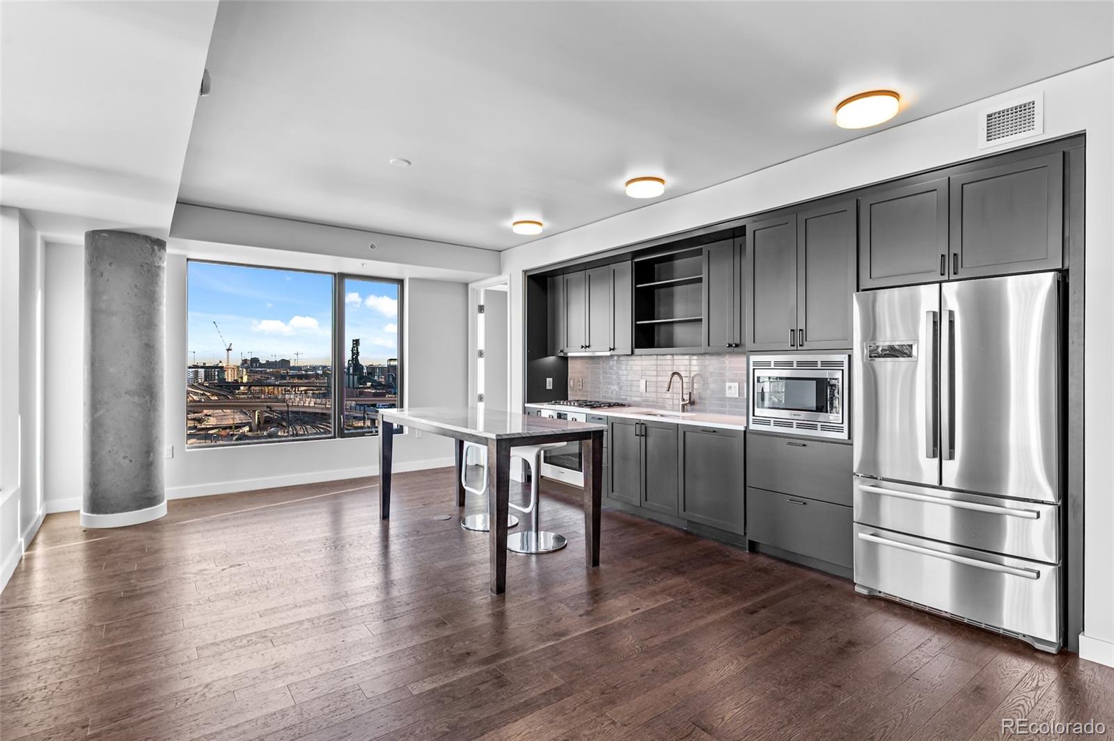 a kitchen with a refrigerator and a stove top oven