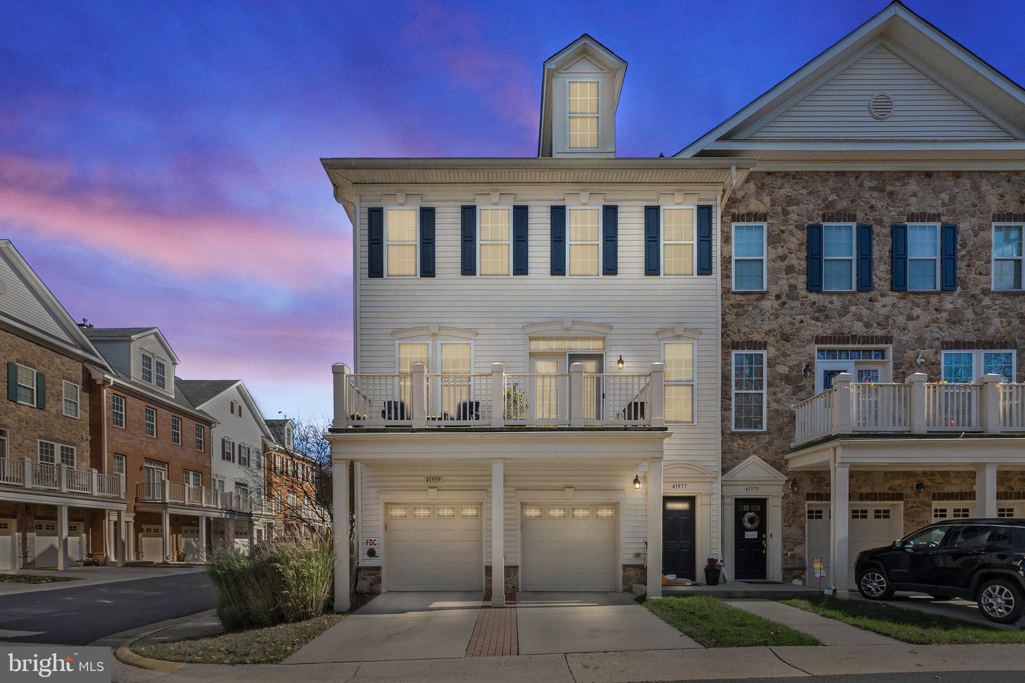 a front view of a residential apartment building with a yard