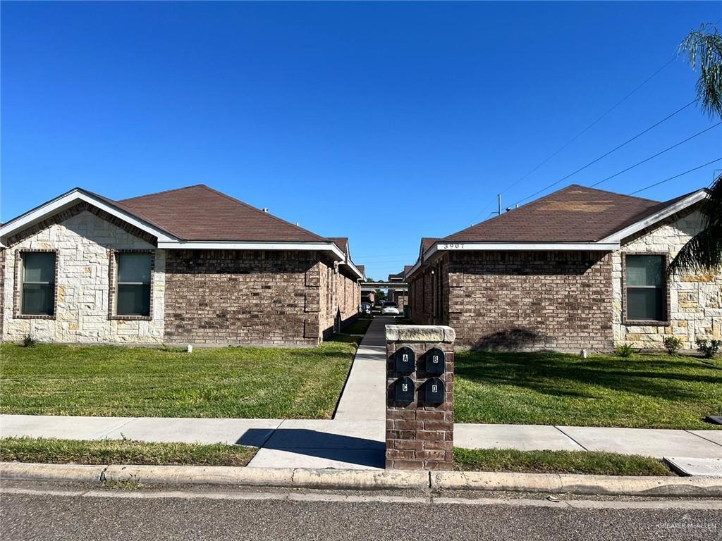 View of property exterior with a yard