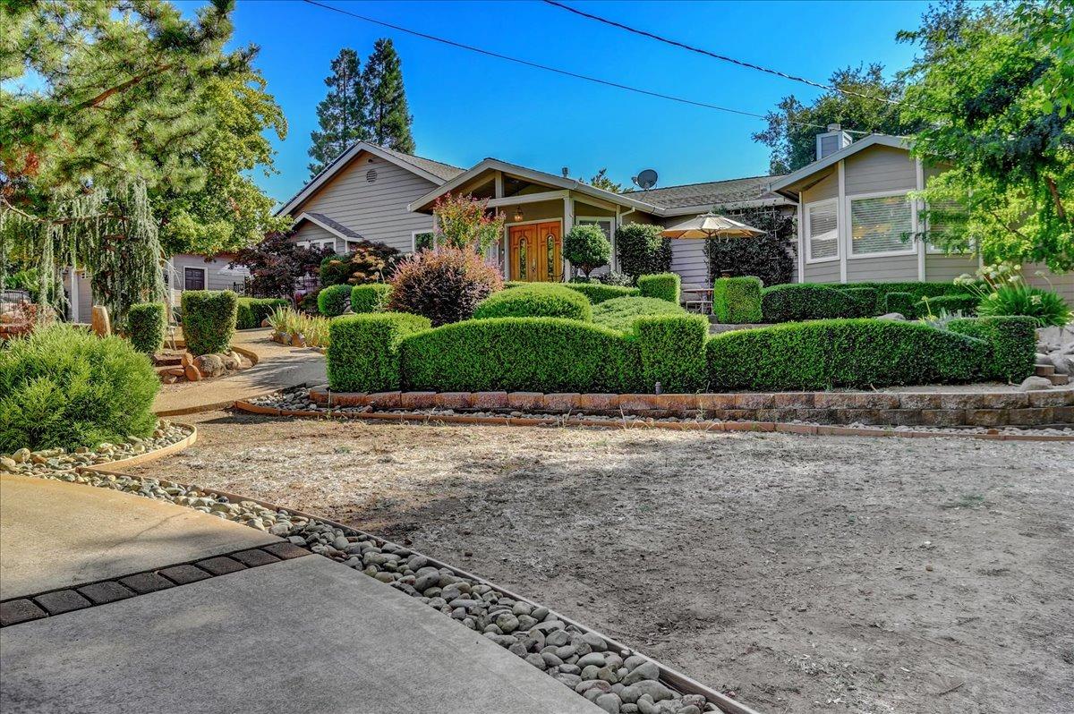 a front view of a house with a garden