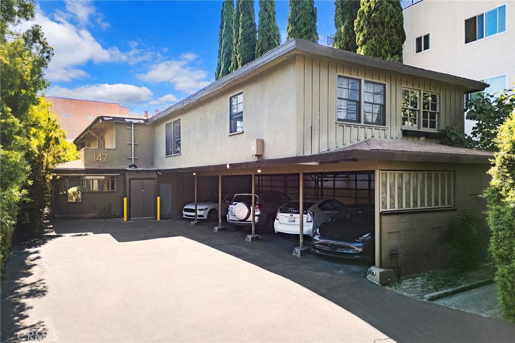 a view of a house with a yard and sitting area