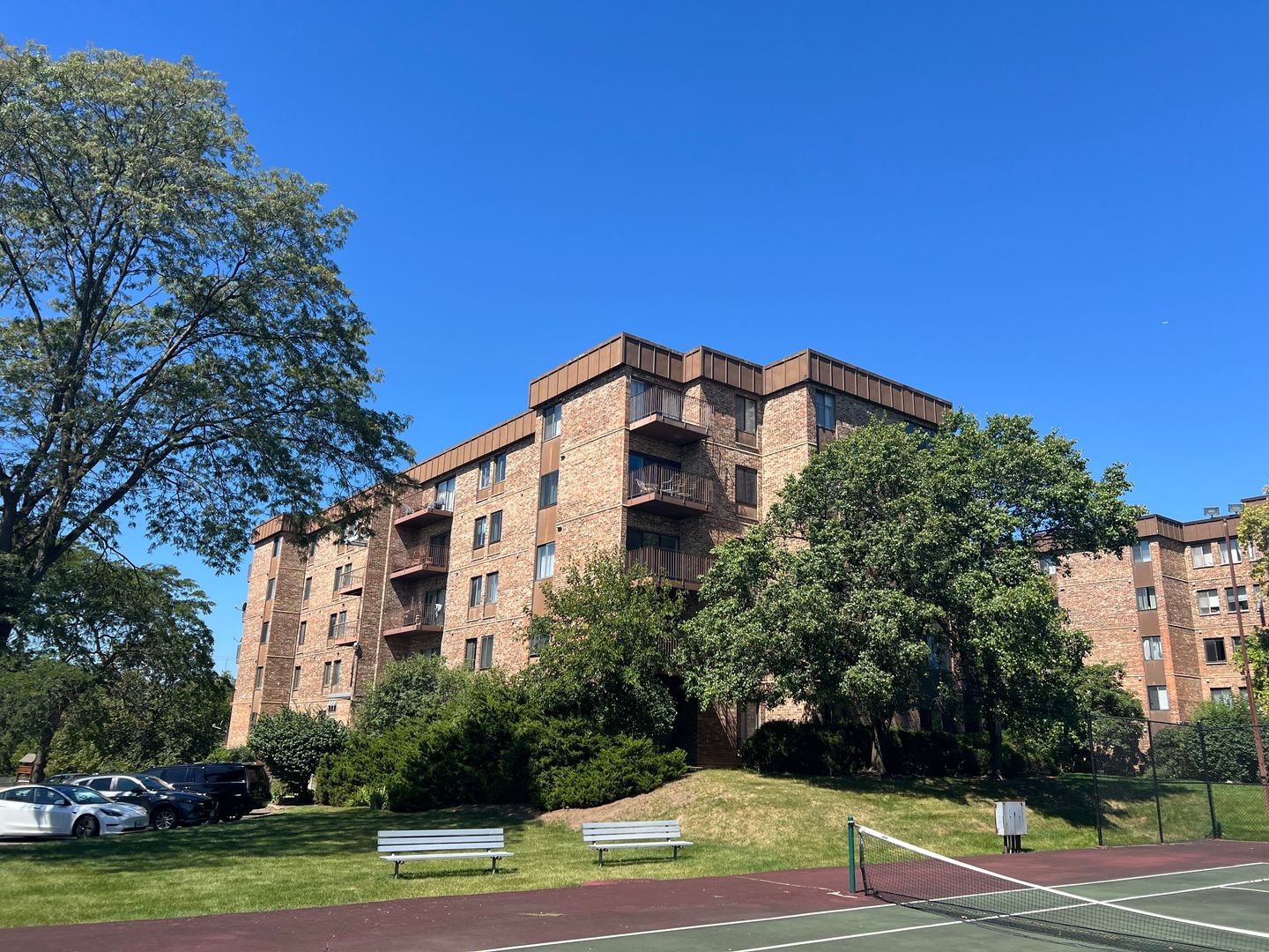 a view of a tall building next to a yard