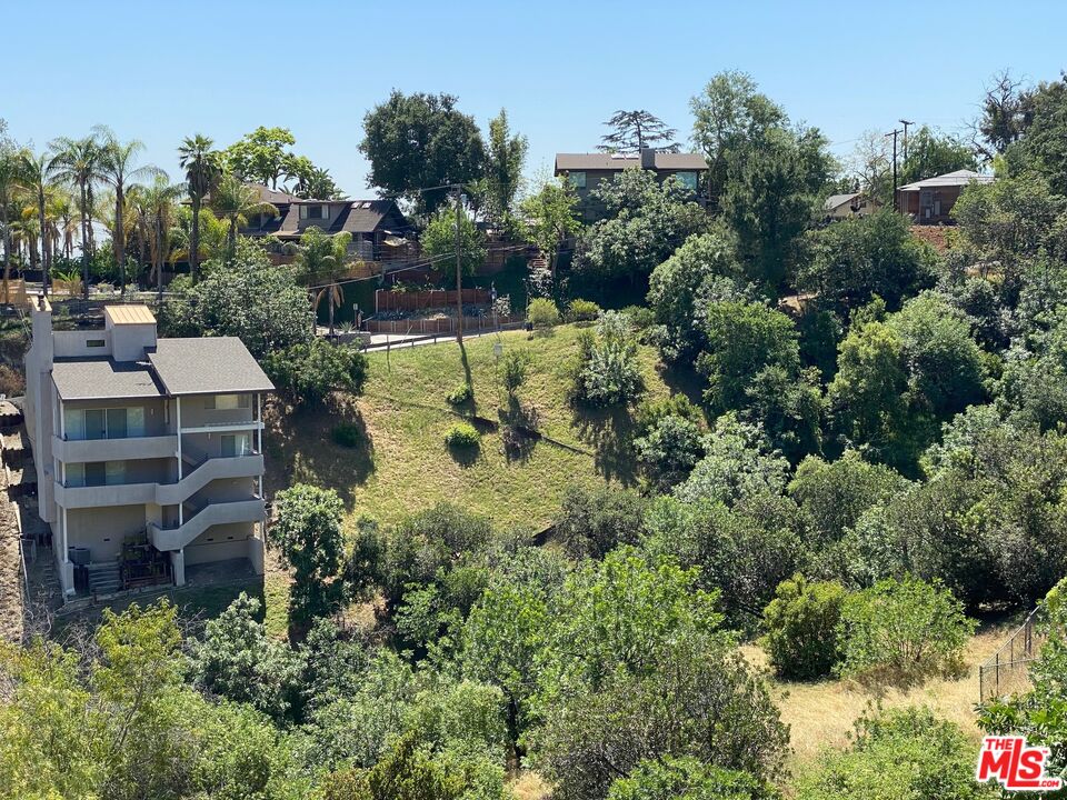 an aerial view of a house with a yard basket ball court and outdoor seating