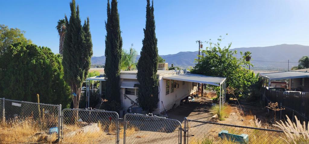 a view of house with swimming pool and outdoor seating