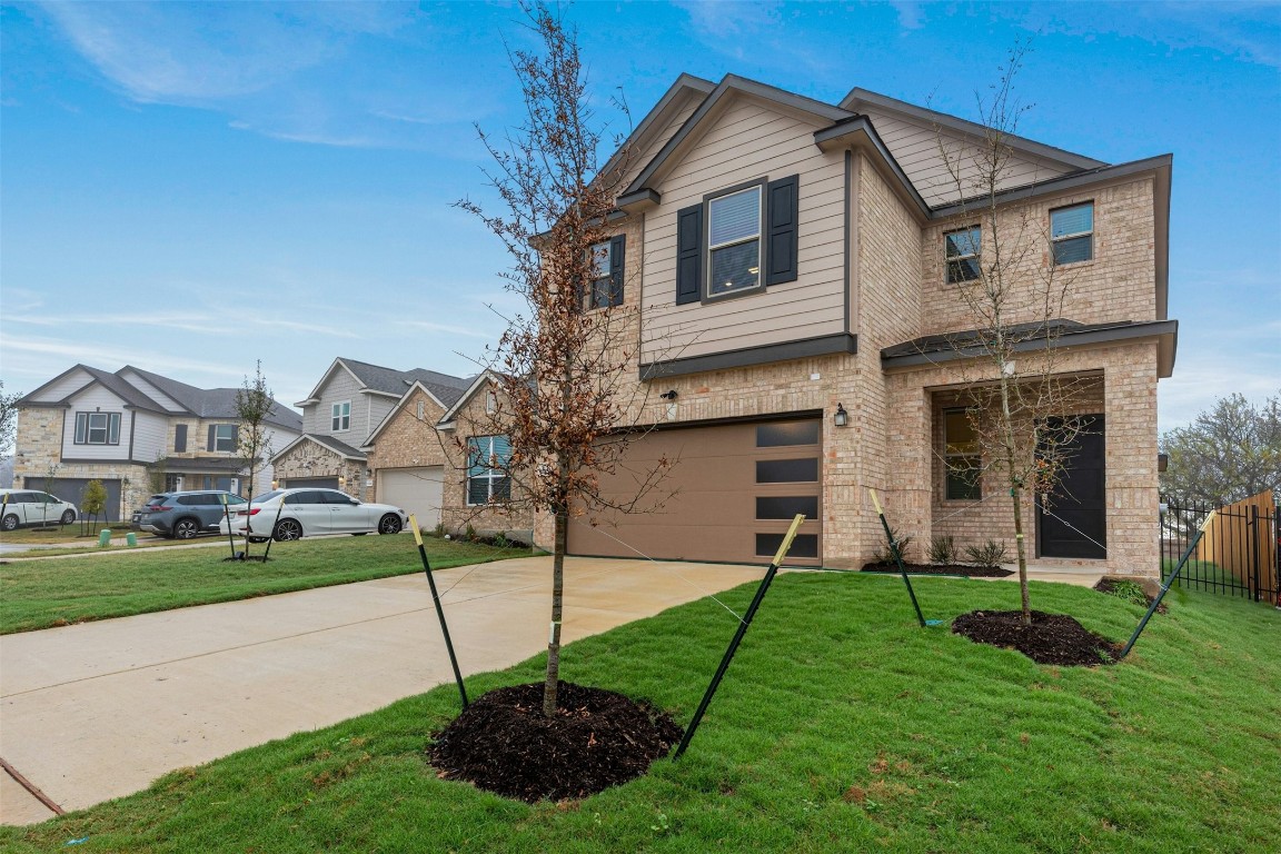 a front view of a house with a yard and garage