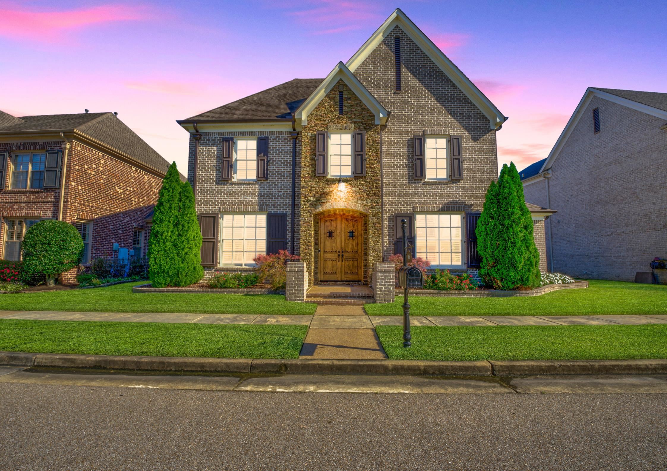 Enjoy a breathtaking dusk view of this gorgeous Germantown home featuring an open floor plan and granite galore. Located within walking distance to Houston Middle and High, it combines elegance and convenience in a desirable neighborhood.