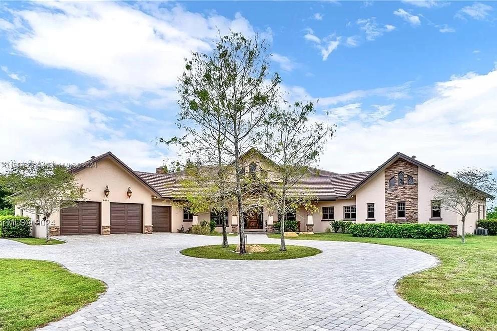 a front view of a house with a yard and garage