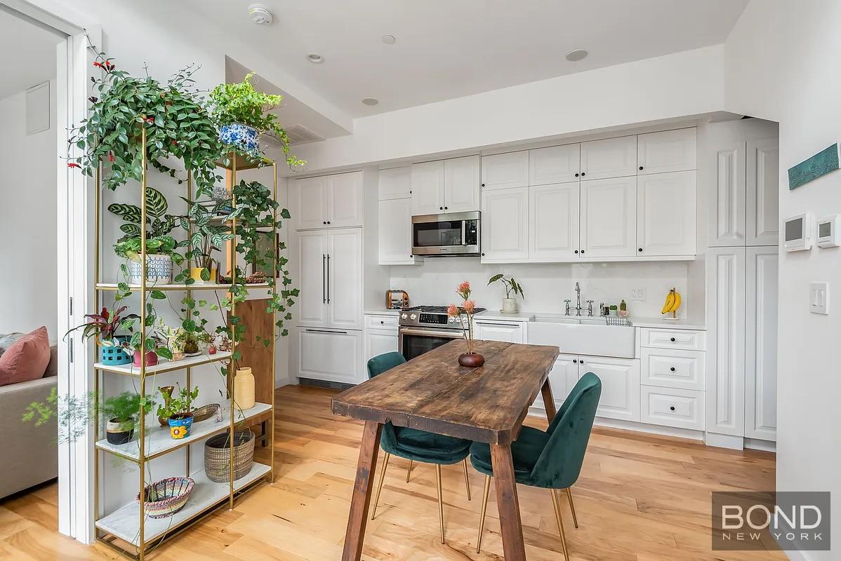 a kitchen with stainless steel appliances kitchen island granite countertop a refrigerator and a stove top oven