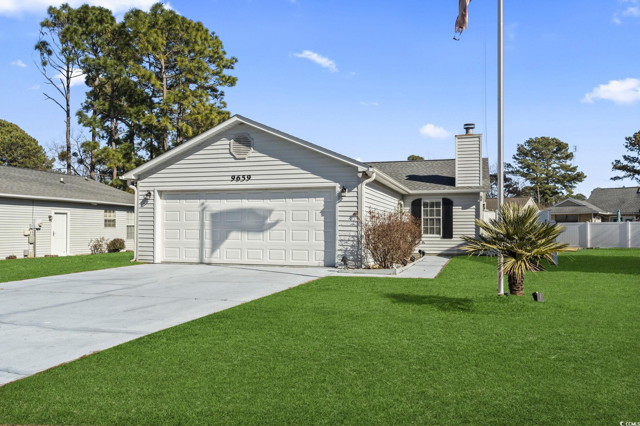 Ranch-style house with a garage and a front yard