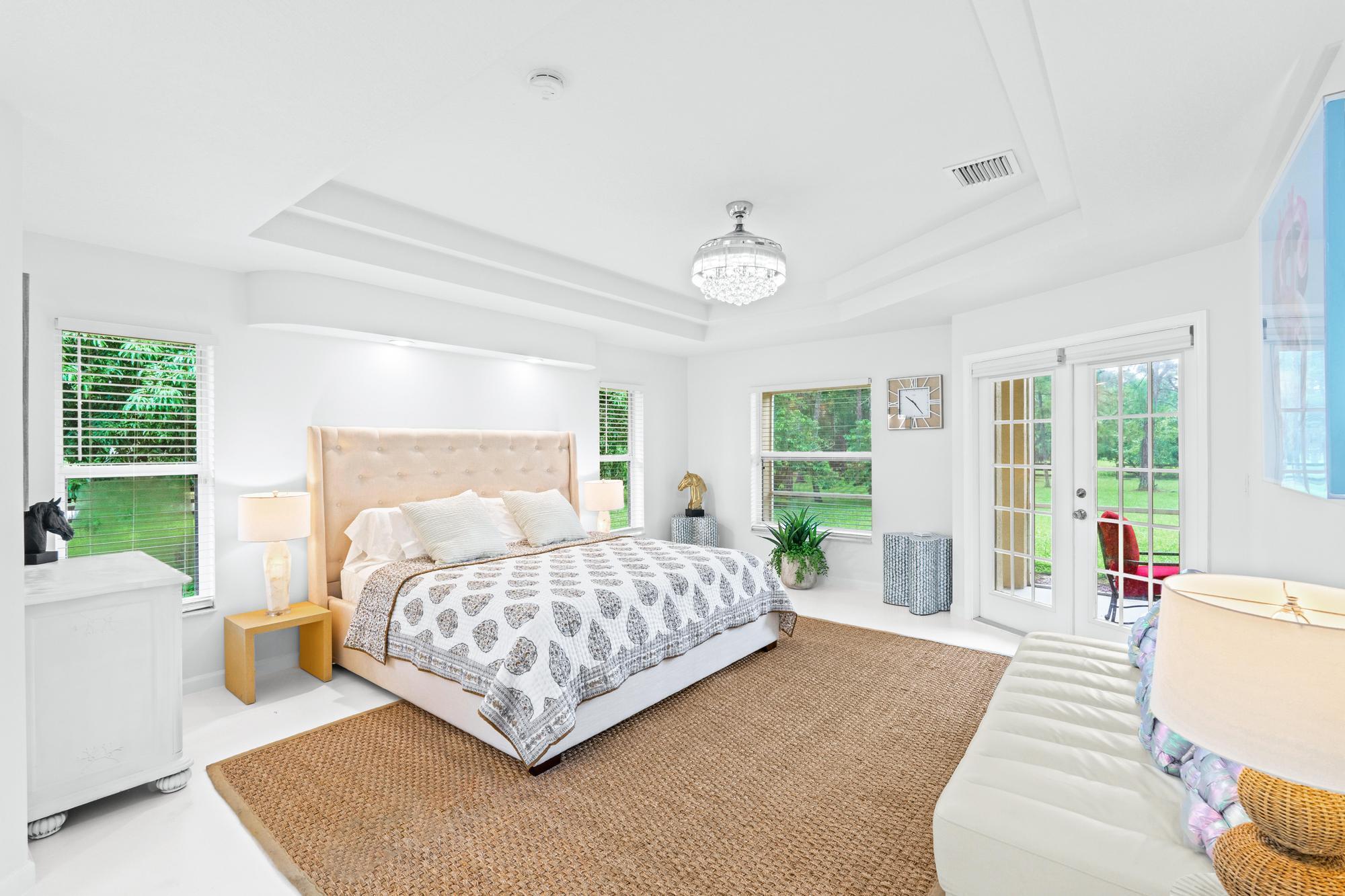 a living room with a bed furniture and a large window