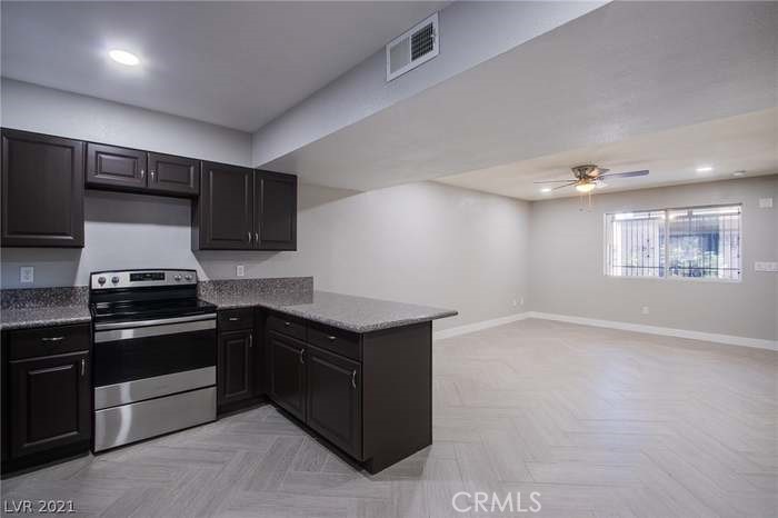 a kitchen with granite countertop a stove and a refrigerator