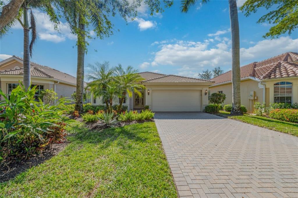 Mediterranean / spanish-style house featuring a front yard and a garage