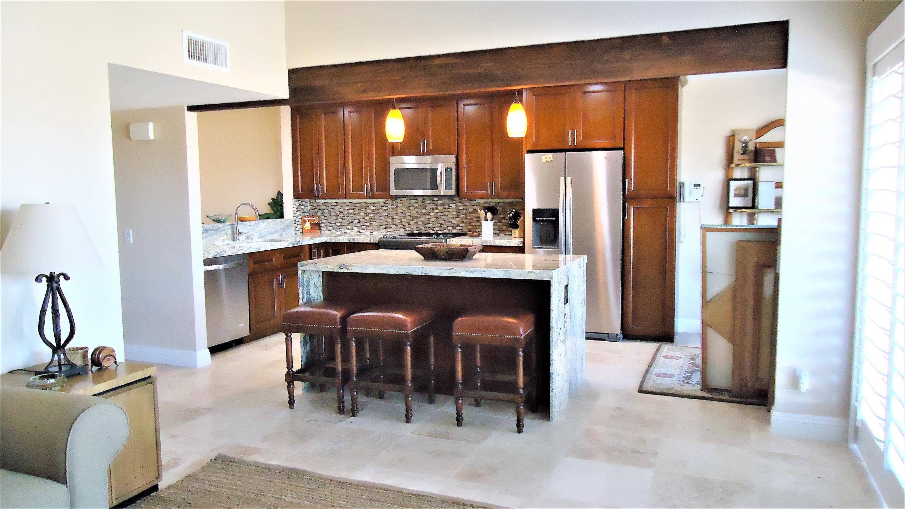 a kitchen with stainless steel appliances a sink stove and refrigerator