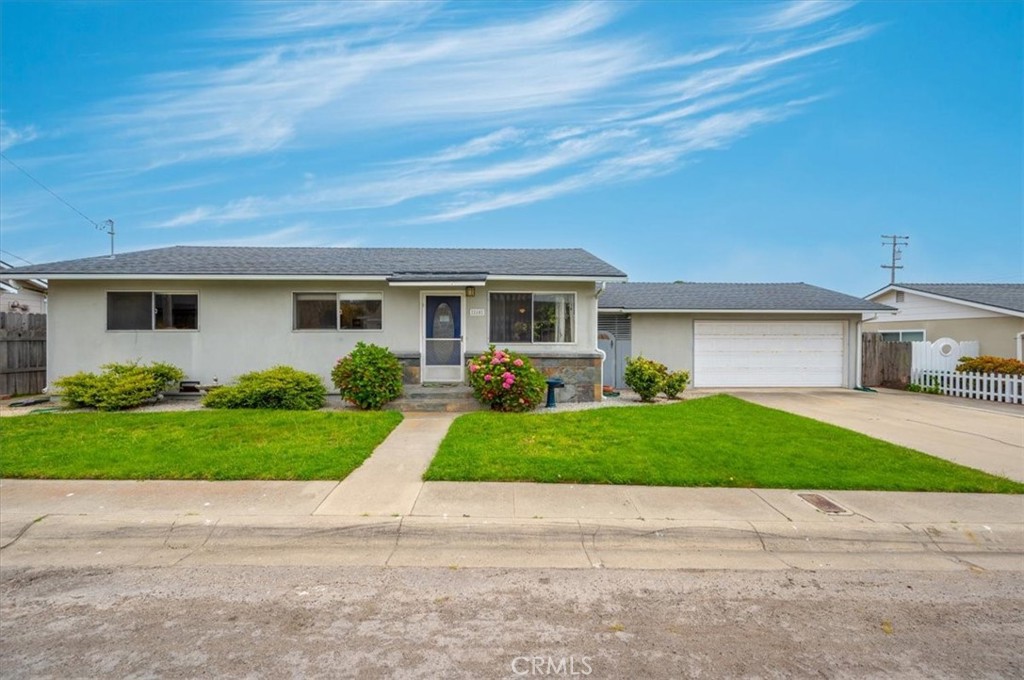 a front view of a house with a yard and a garage