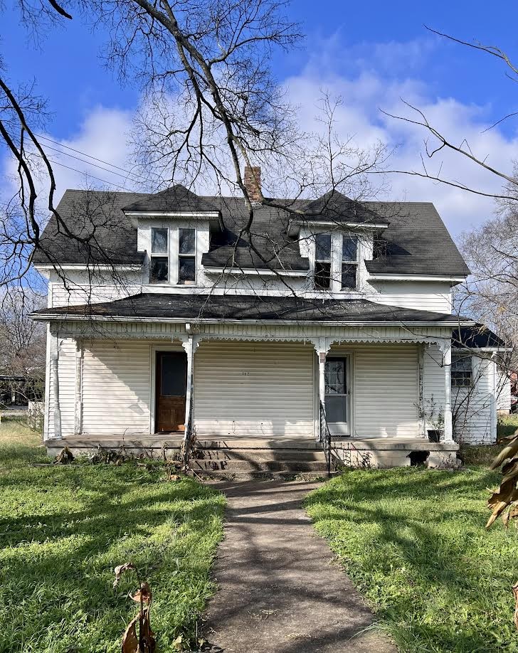 a view of house with yard