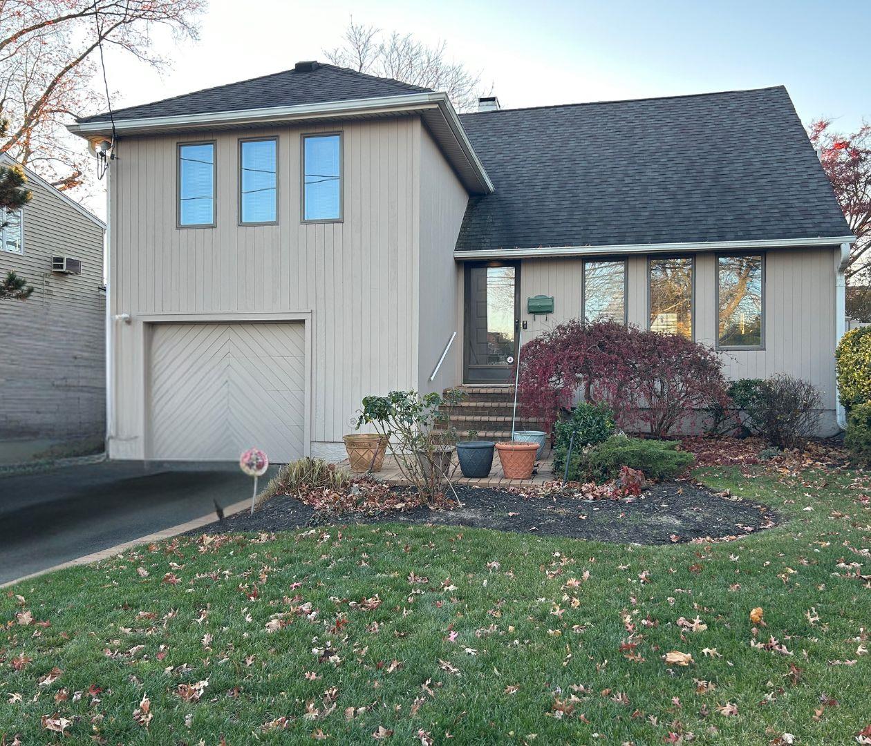 a front view of house with yard and outdoor seating