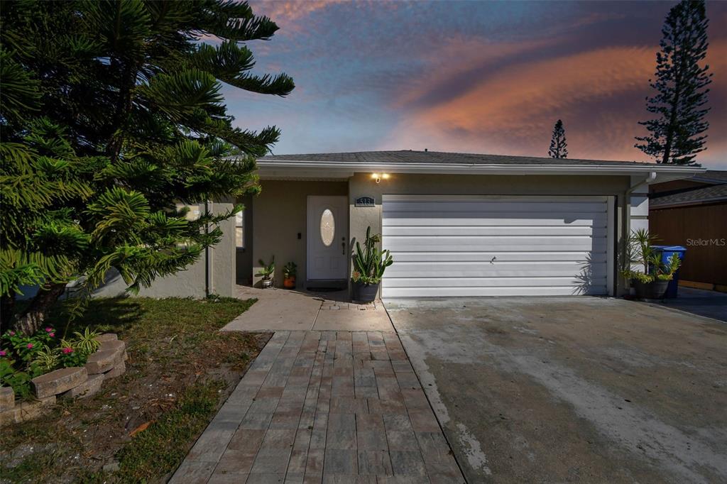 a view of a house with a yard and garage