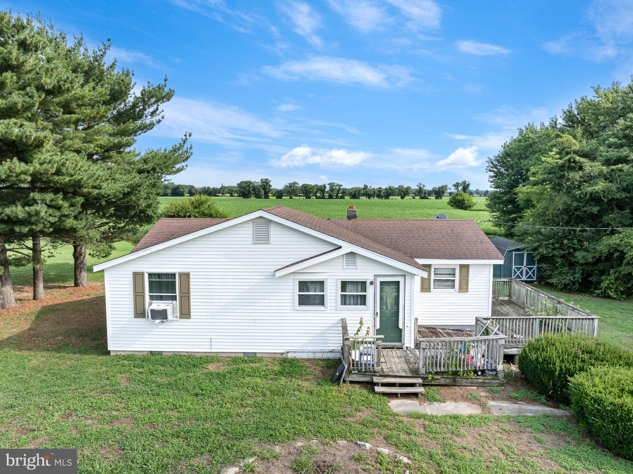 a view of house with backyard and outdoor seating