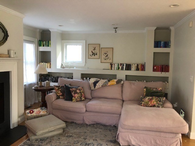 a living room with furniture and a fireplace