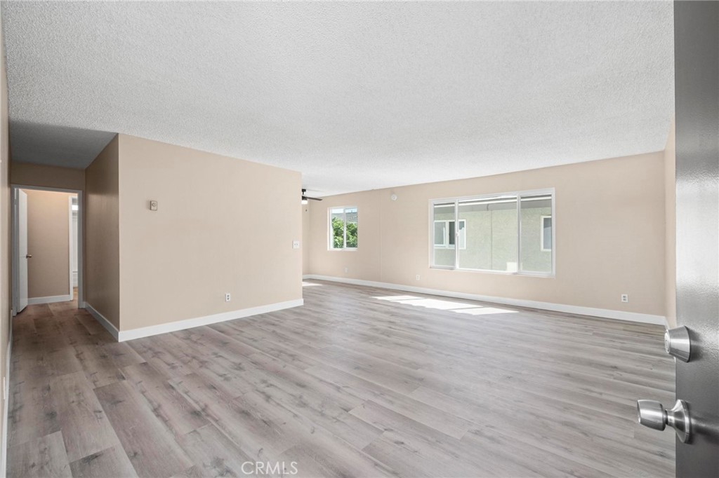 a view of empty room with wooden floor