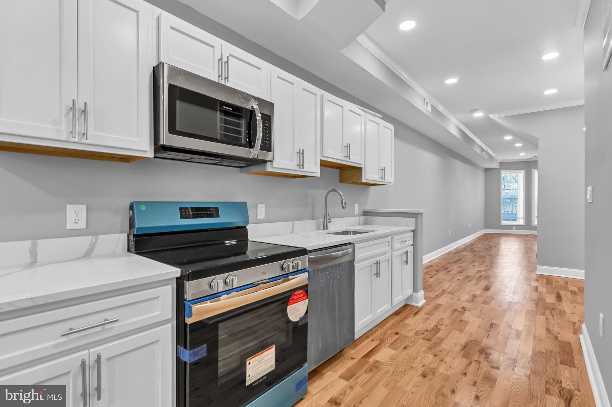 a kitchen with stainless steel appliances granite countertop a sink and stove top oven