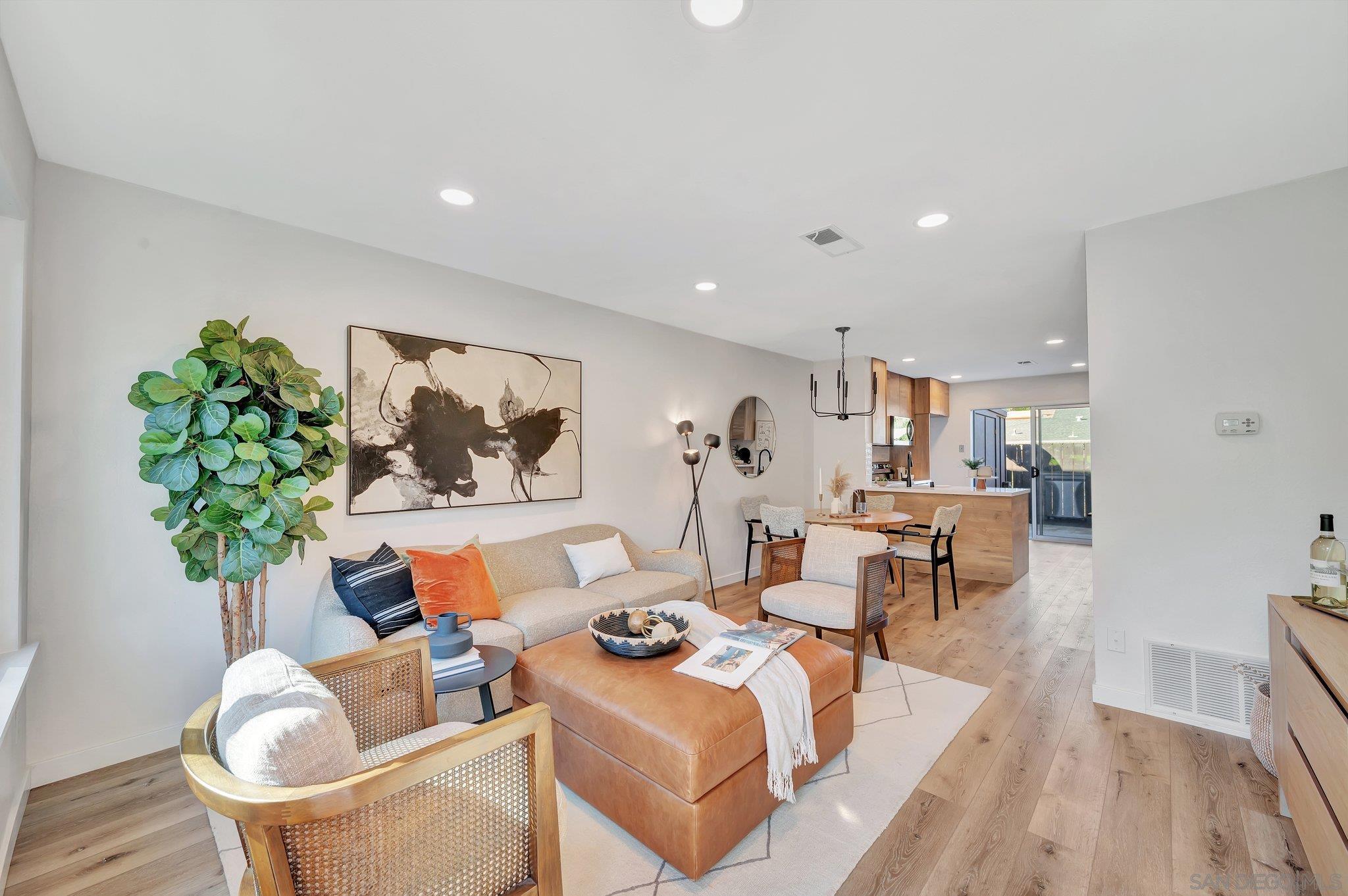 a living room with furniture and a potted plant