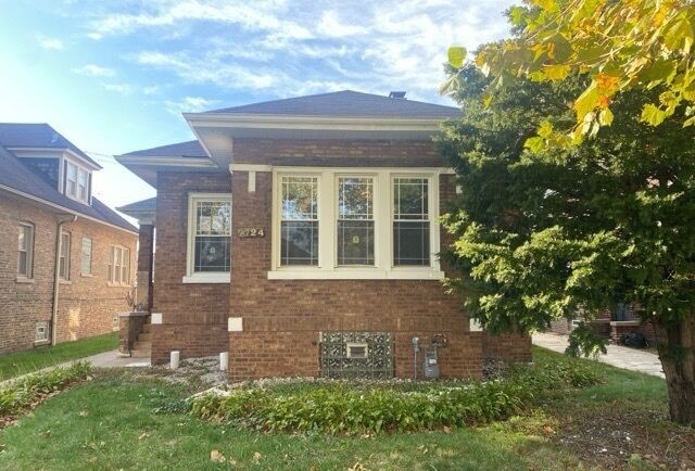 a view of a brick house with a yard