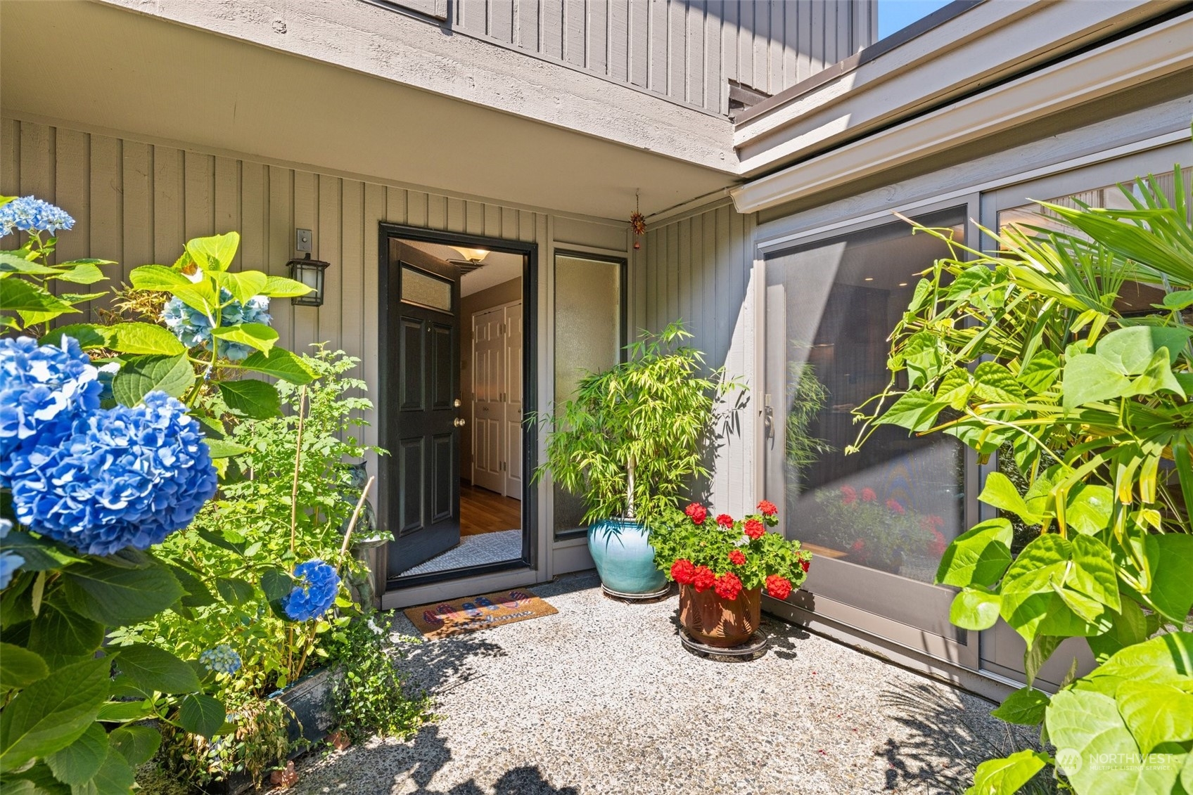 a vase with flowers in front of the house