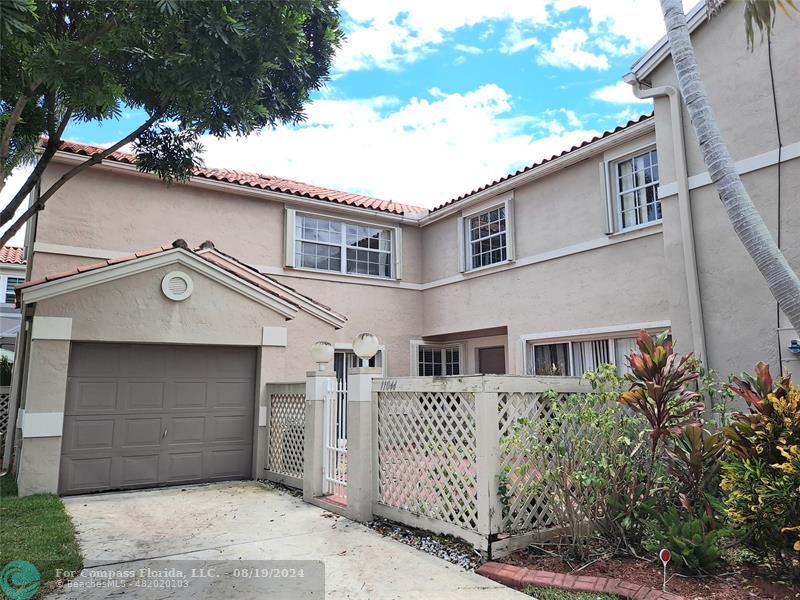 a front view of a house with parking space