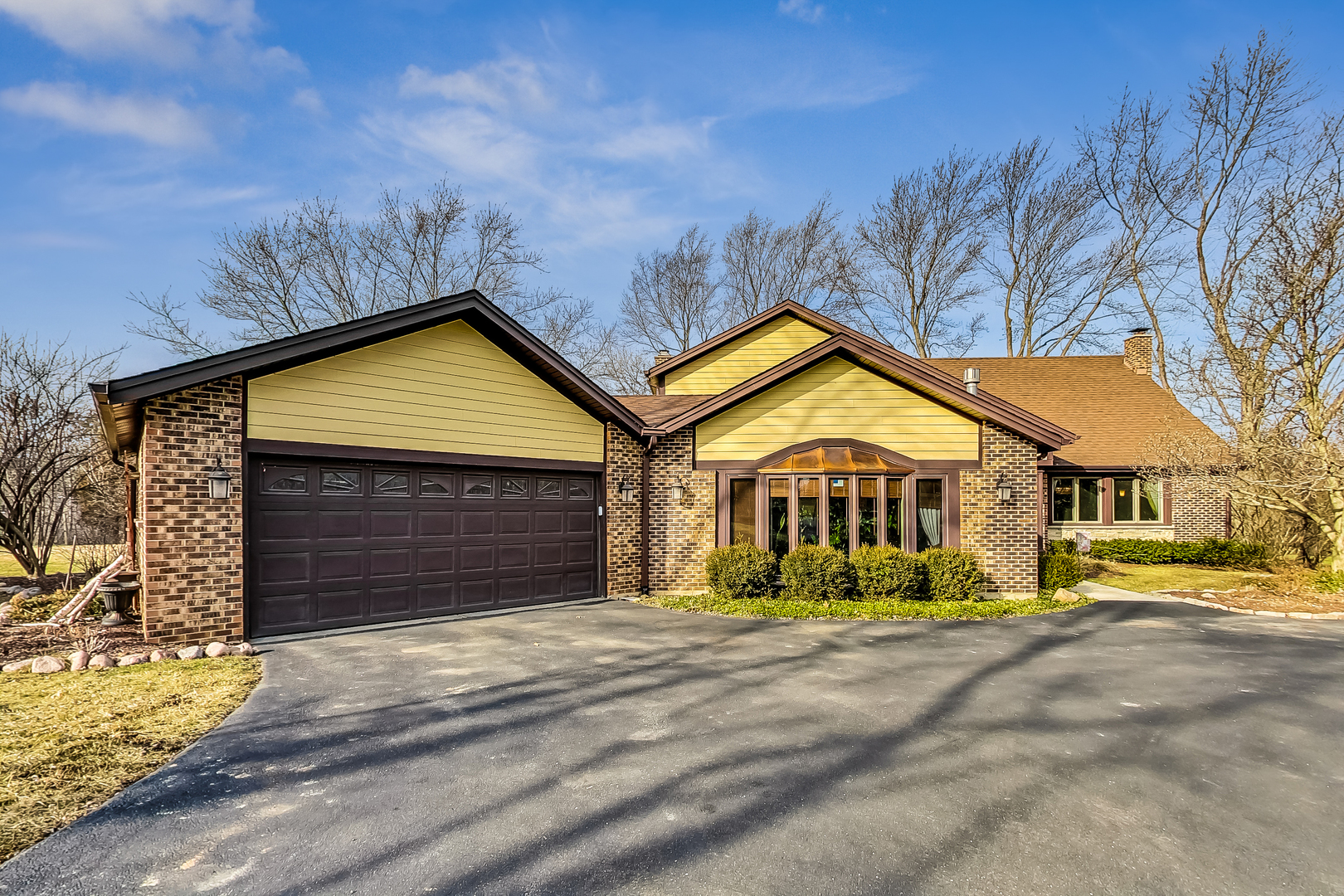 a view of a house with a yard and garage