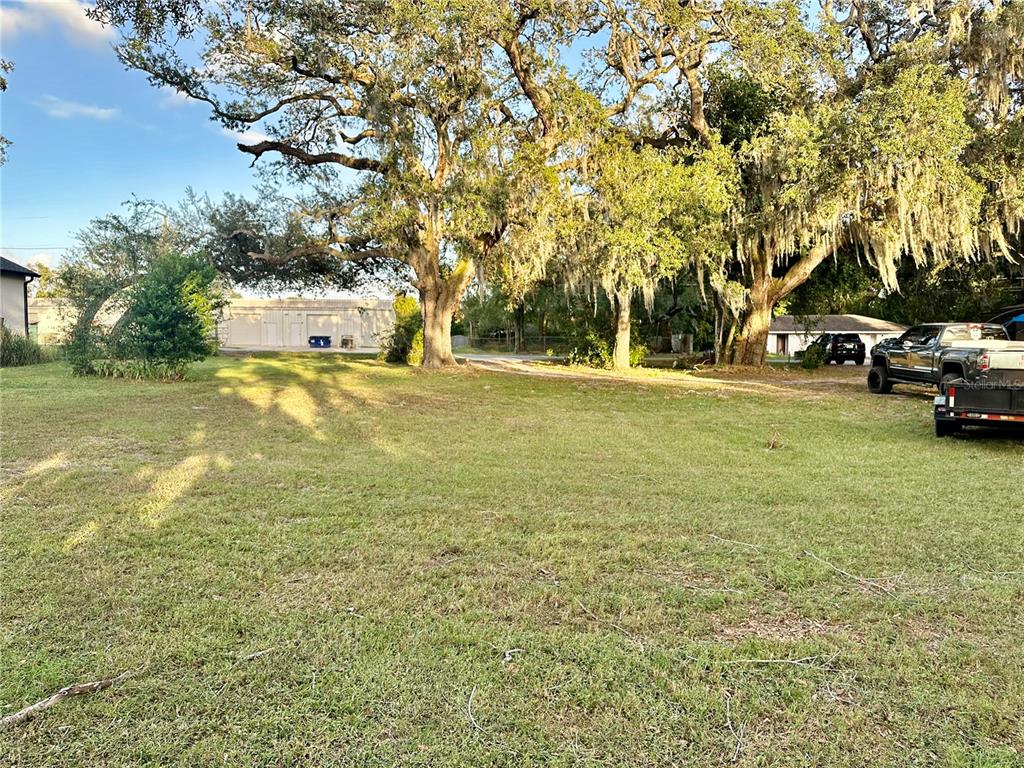 a view of yard with swimming pool and trees