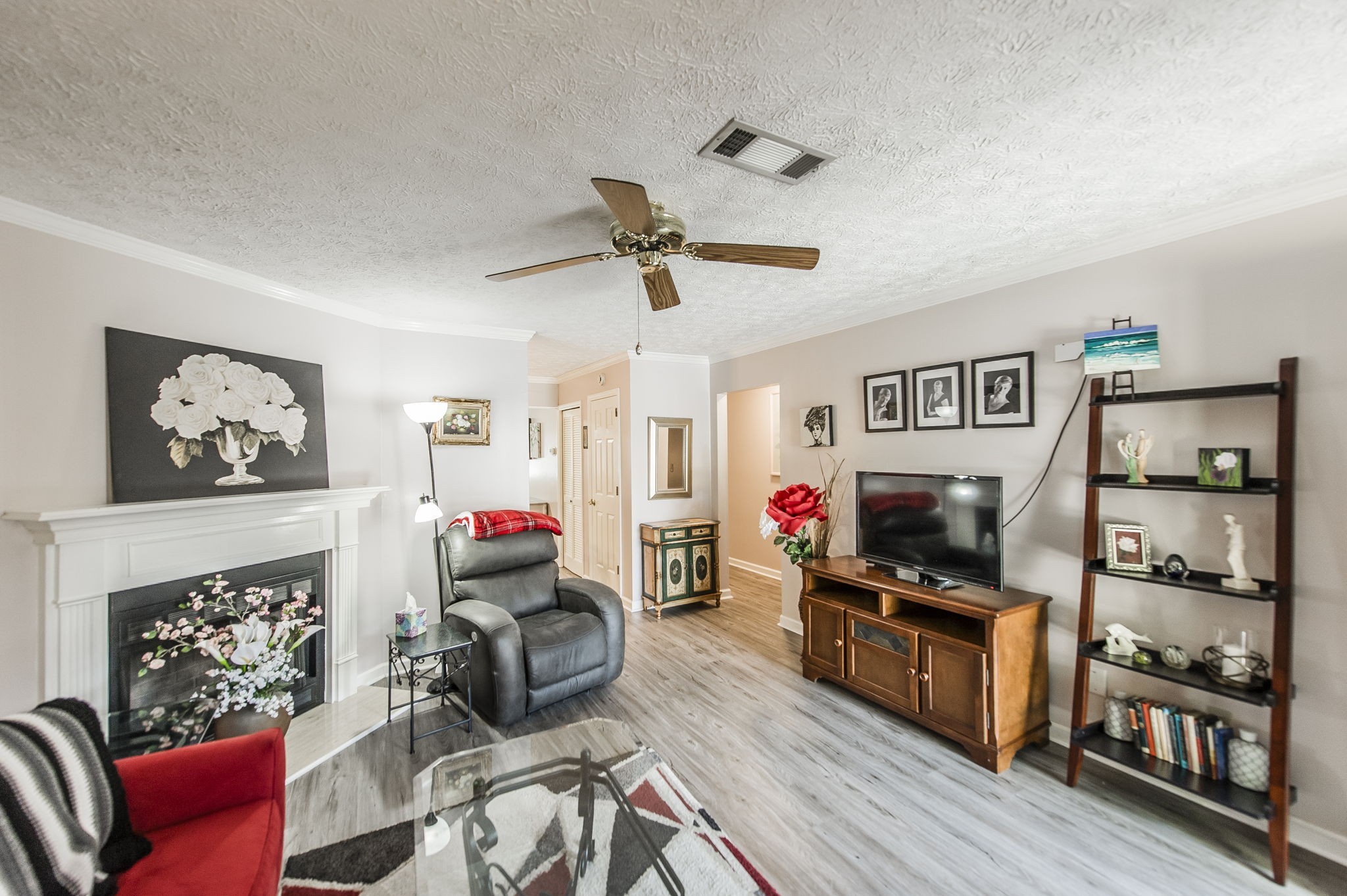 a living room with furniture a window and a flat screen tv